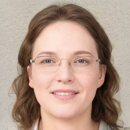 Joyful white young-adult female with long  brown hair and blue eyes