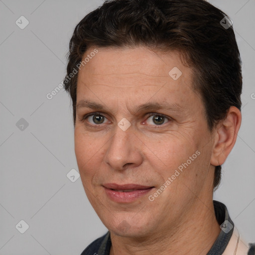 Joyful white adult male with short  brown hair and brown eyes