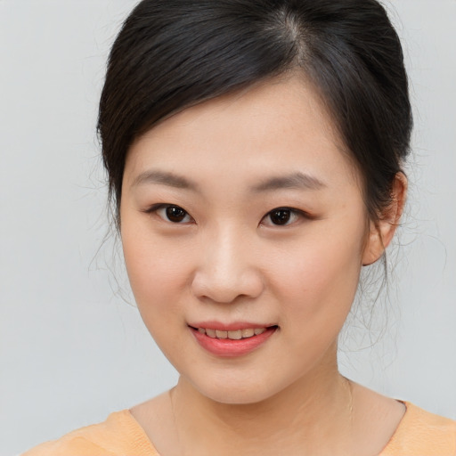Joyful asian child female with medium  brown hair and brown eyes