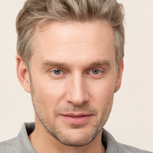 Joyful white adult male with short  brown hair and grey eyes