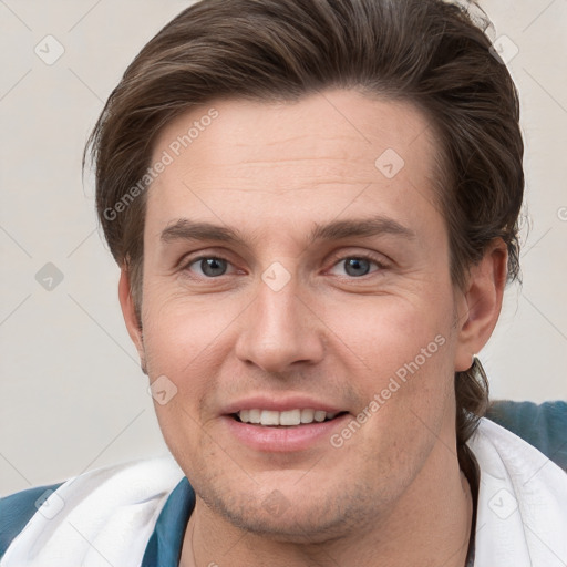 Joyful white young-adult male with short  brown hair and grey eyes