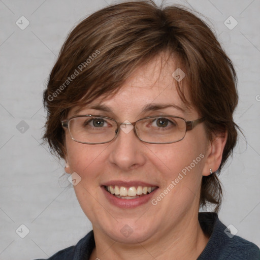 Joyful white adult female with medium  brown hair and blue eyes