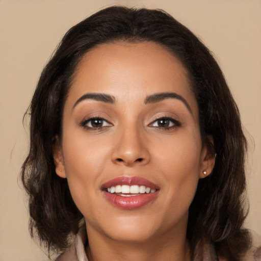 Joyful latino young-adult female with long  brown hair and brown eyes