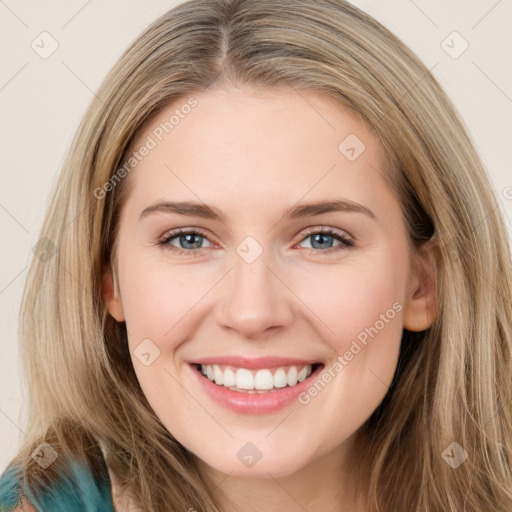 Joyful white young-adult female with long  brown hair and blue eyes