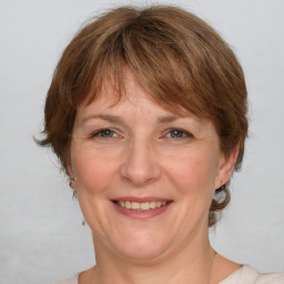 Joyful white adult female with medium  brown hair and grey eyes