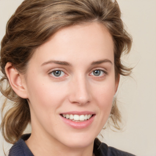 Joyful white young-adult female with medium  brown hair and blue eyes