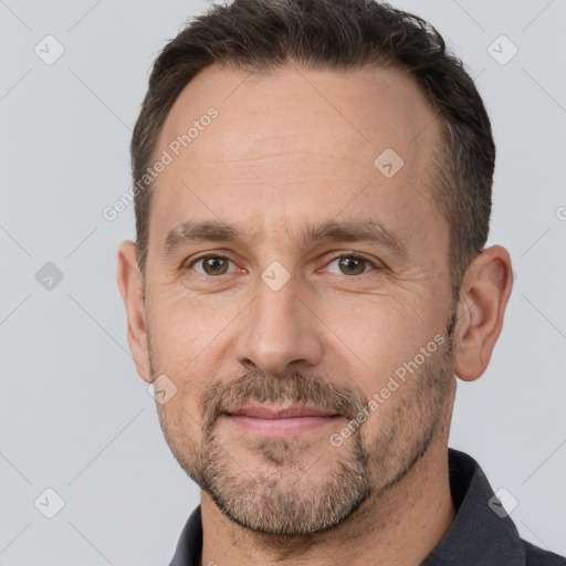 Joyful white adult male with short  brown hair and brown eyes