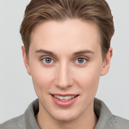 Joyful white young-adult female with short  brown hair and grey eyes