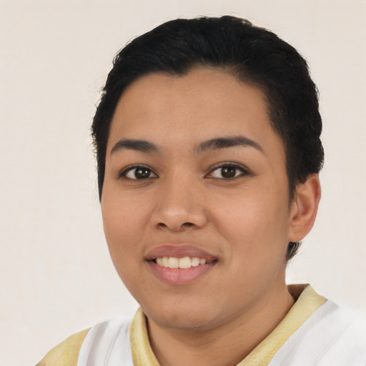 Joyful latino young-adult female with short  black hair and brown eyes