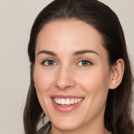 Joyful white young-adult female with long  brown hair and brown eyes