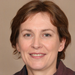 Joyful white adult female with medium  brown hair and grey eyes