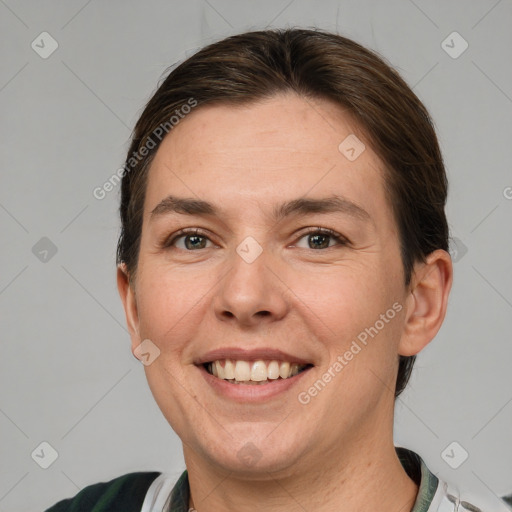 Joyful white adult female with short  brown hair and grey eyes