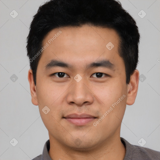 Joyful asian young-adult male with short  black hair and brown eyes