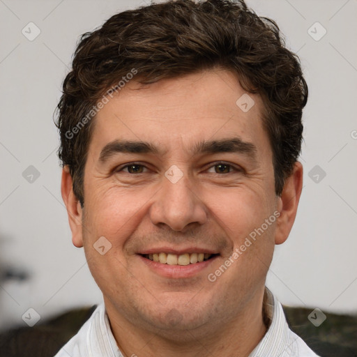 Joyful white adult male with short  brown hair and brown eyes