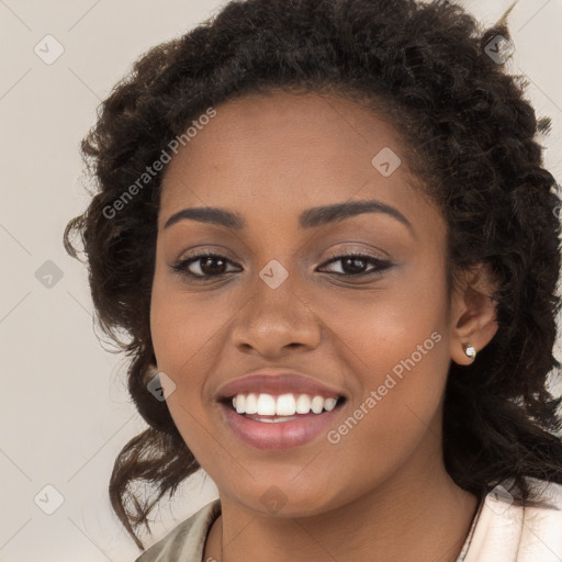 Joyful black young-adult female with long  brown hair and brown eyes