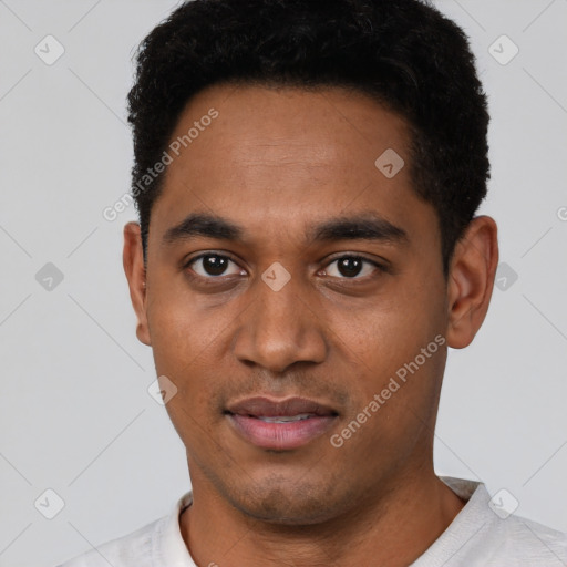 Joyful black young-adult male with short  black hair and brown eyes