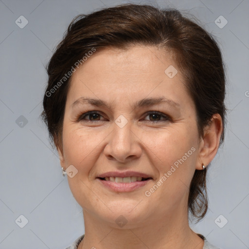 Joyful white adult female with medium  brown hair and brown eyes