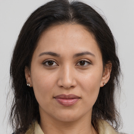 Joyful latino young-adult female with long  brown hair and brown eyes