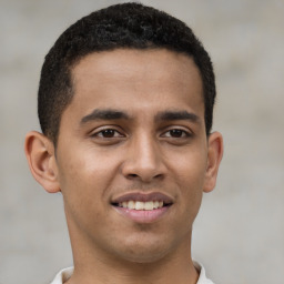 Joyful latino young-adult male with short  brown hair and brown eyes