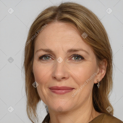 Joyful white adult female with medium  brown hair and grey eyes