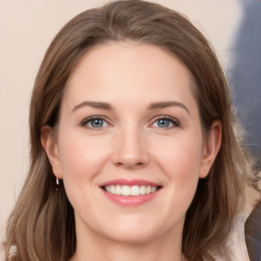 Joyful white young-adult female with long  brown hair and grey eyes