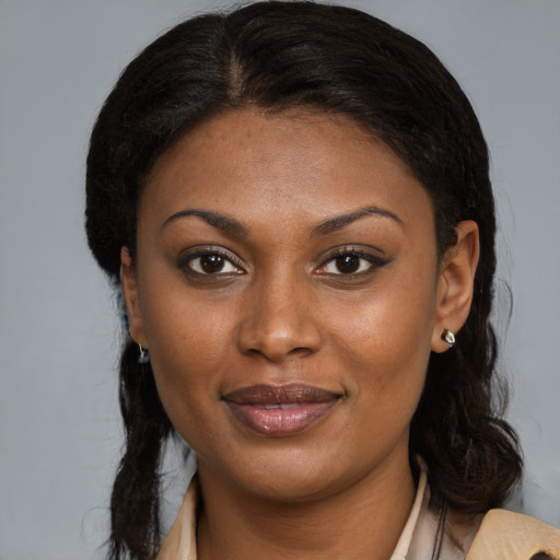 Joyful black young-adult female with medium  brown hair and brown eyes