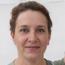 Joyful white adult female with short  brown hair and grey eyes