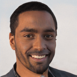 Joyful black young-adult male with short  brown hair and brown eyes