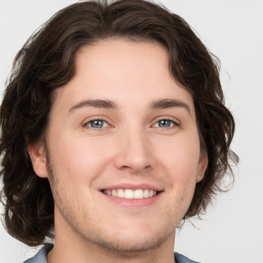 Joyful white young-adult male with medium  brown hair and brown eyes