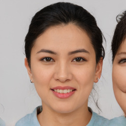 Joyful asian young-adult female with medium  brown hair and brown eyes