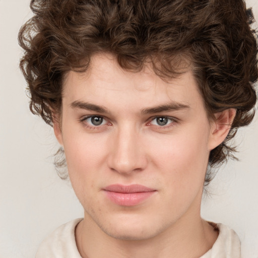 Joyful white young-adult male with medium  brown hair and brown eyes