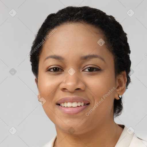 Joyful black young-adult female with short  black hair and brown eyes