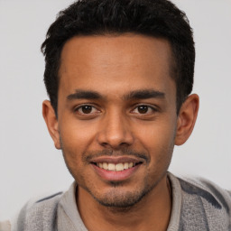 Joyful white young-adult male with short  black hair and brown eyes