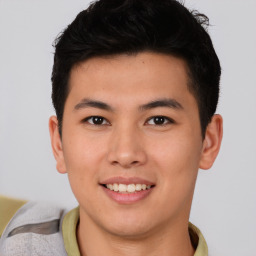 Joyful asian young-adult male with short  brown hair and brown eyes