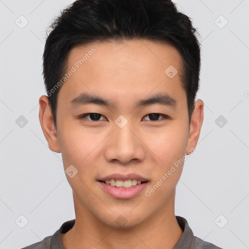 Joyful asian young-adult male with short  brown hair and brown eyes