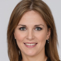 Joyful white young-adult female with long  brown hair and grey eyes