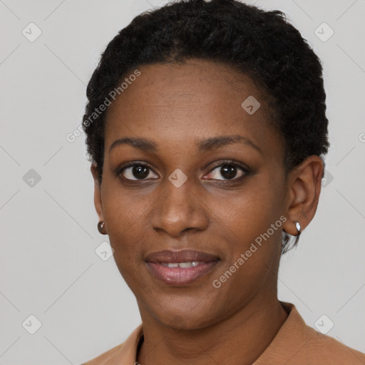 Joyful black young-adult female with short  black hair and brown eyes