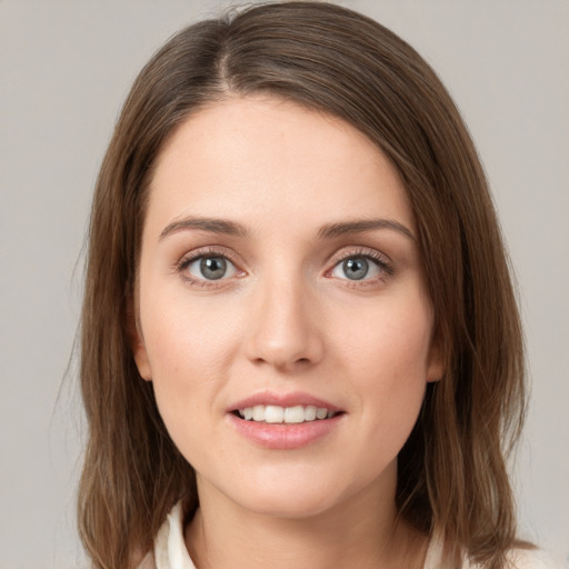 Joyful white young-adult female with medium  brown hair and green eyes