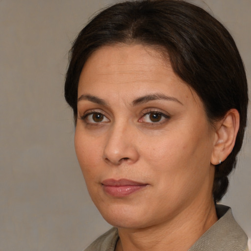 Joyful white adult female with medium  brown hair and brown eyes