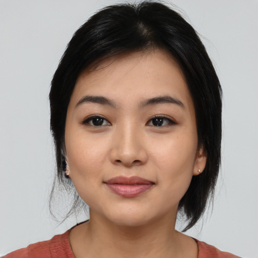 Joyful asian young-adult female with medium  black hair and brown eyes