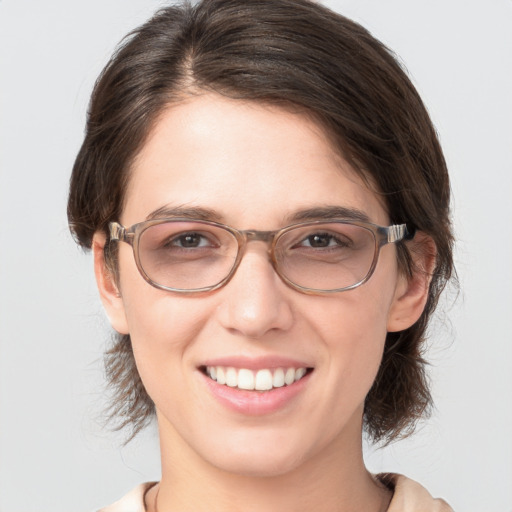 Joyful white young-adult female with medium  brown hair and grey eyes