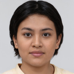 Joyful asian young-adult female with medium  brown hair and brown eyes