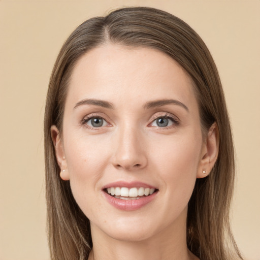 Joyful white young-adult female with long  brown hair and grey eyes