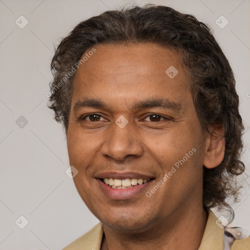 Joyful latino adult male with short  brown hair and brown eyes