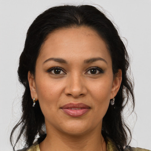 Joyful latino young-adult female with medium  brown hair and brown eyes