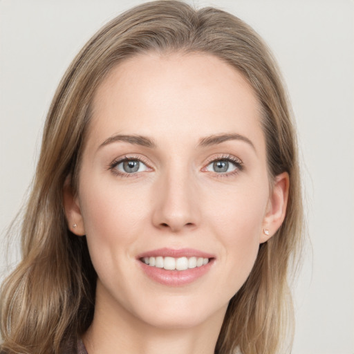 Joyful white young-adult female with long  brown hair and blue eyes