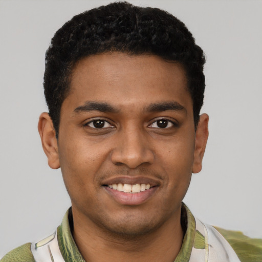 Joyful black young-adult male with short  black hair and brown eyes