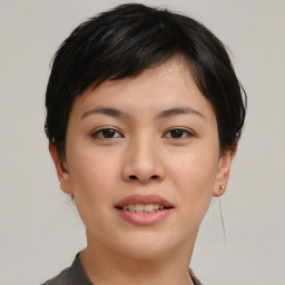 Joyful asian young-adult female with short  brown hair and brown eyes