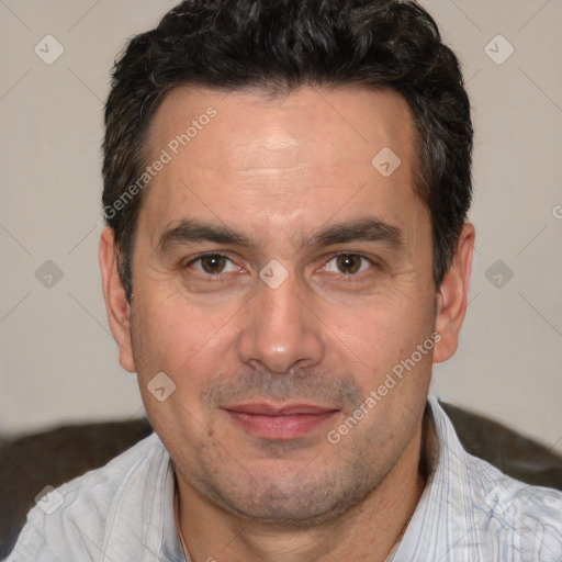 Joyful white adult male with short  black hair and brown eyes