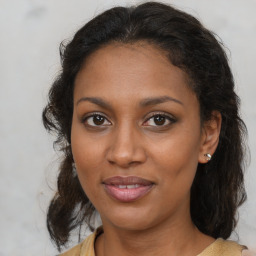 Joyful black young-adult female with medium  brown hair and brown eyes